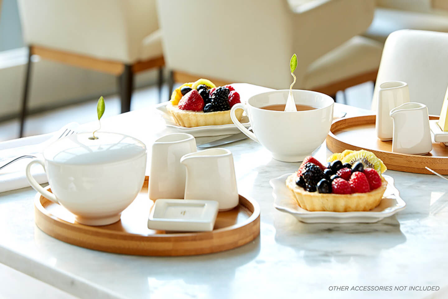 Café Cups on a cafe table with fruit tarts, Oval Trays, sugar & Creamer sets and Tea Trays.