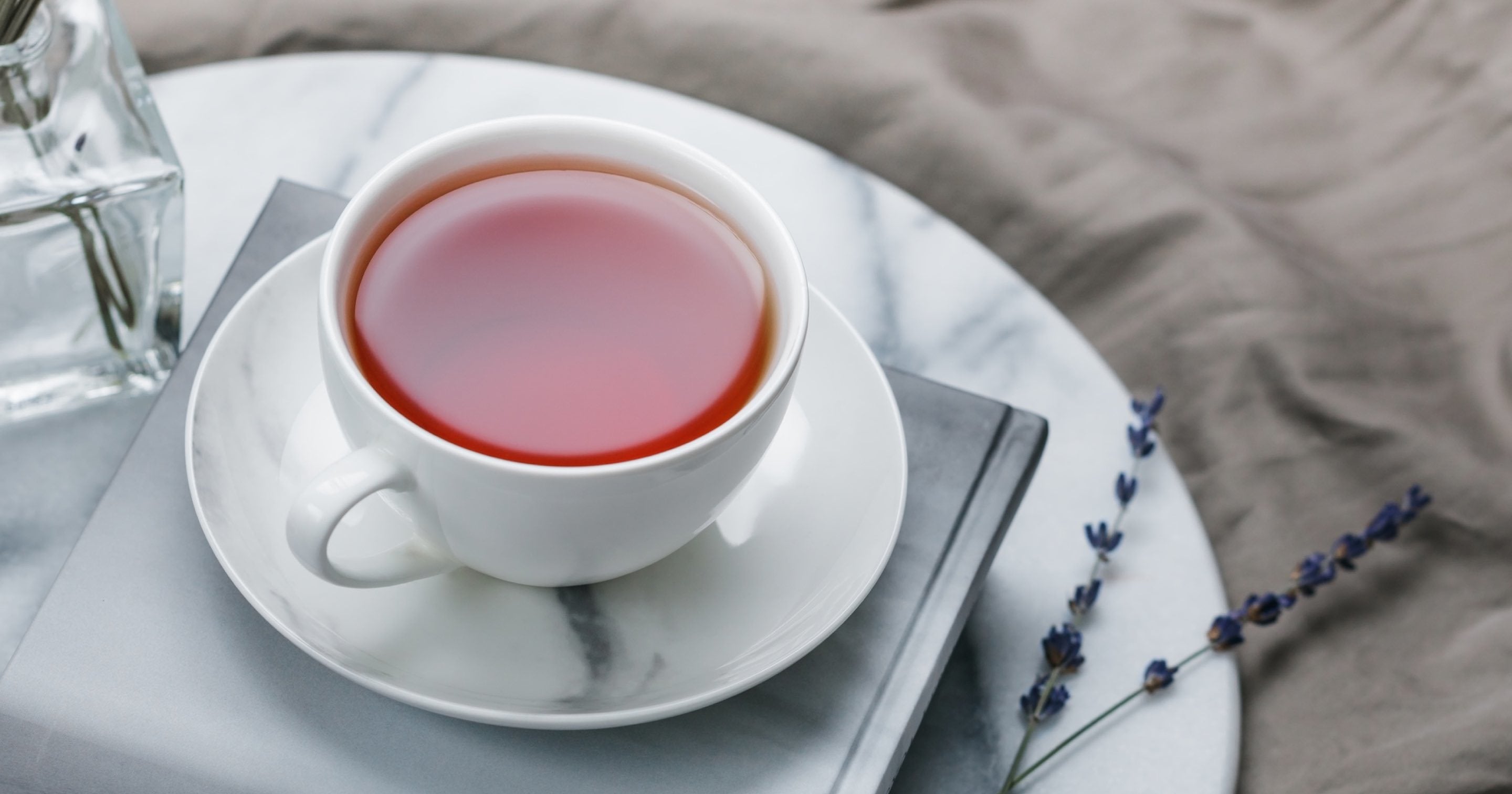 A white cup and saucer of earl grey tea