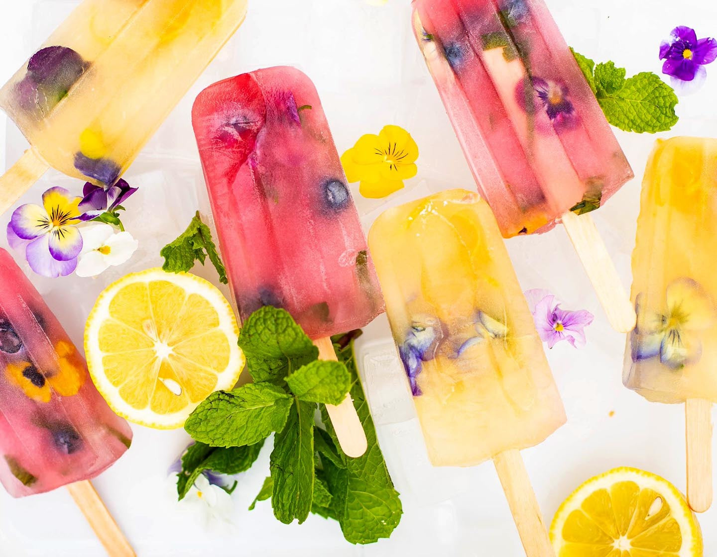 Iced Tea Popsicles with fresh fruit and herbs, from above