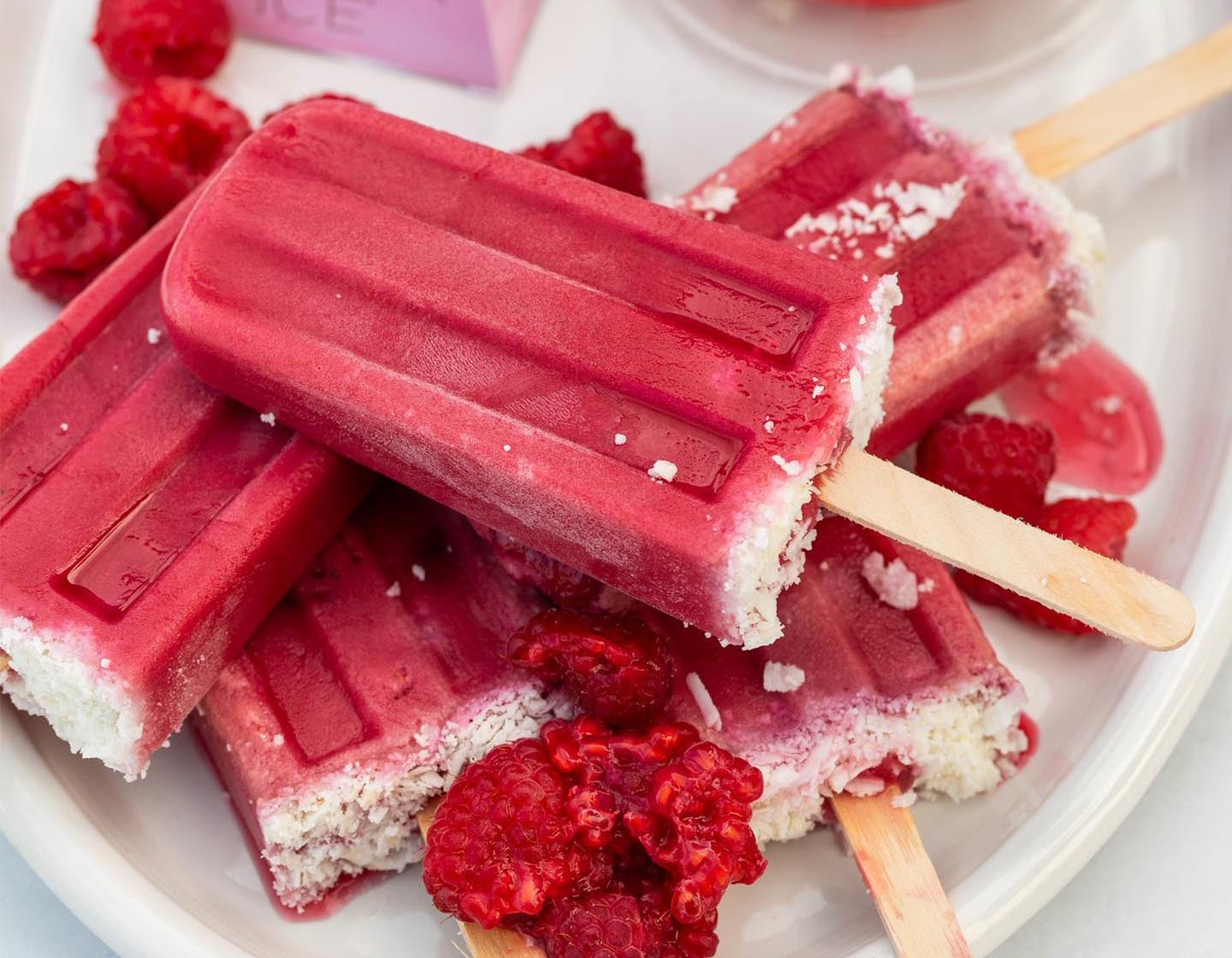 Raspberry Coconut Tea Popsicles piled on a white plate