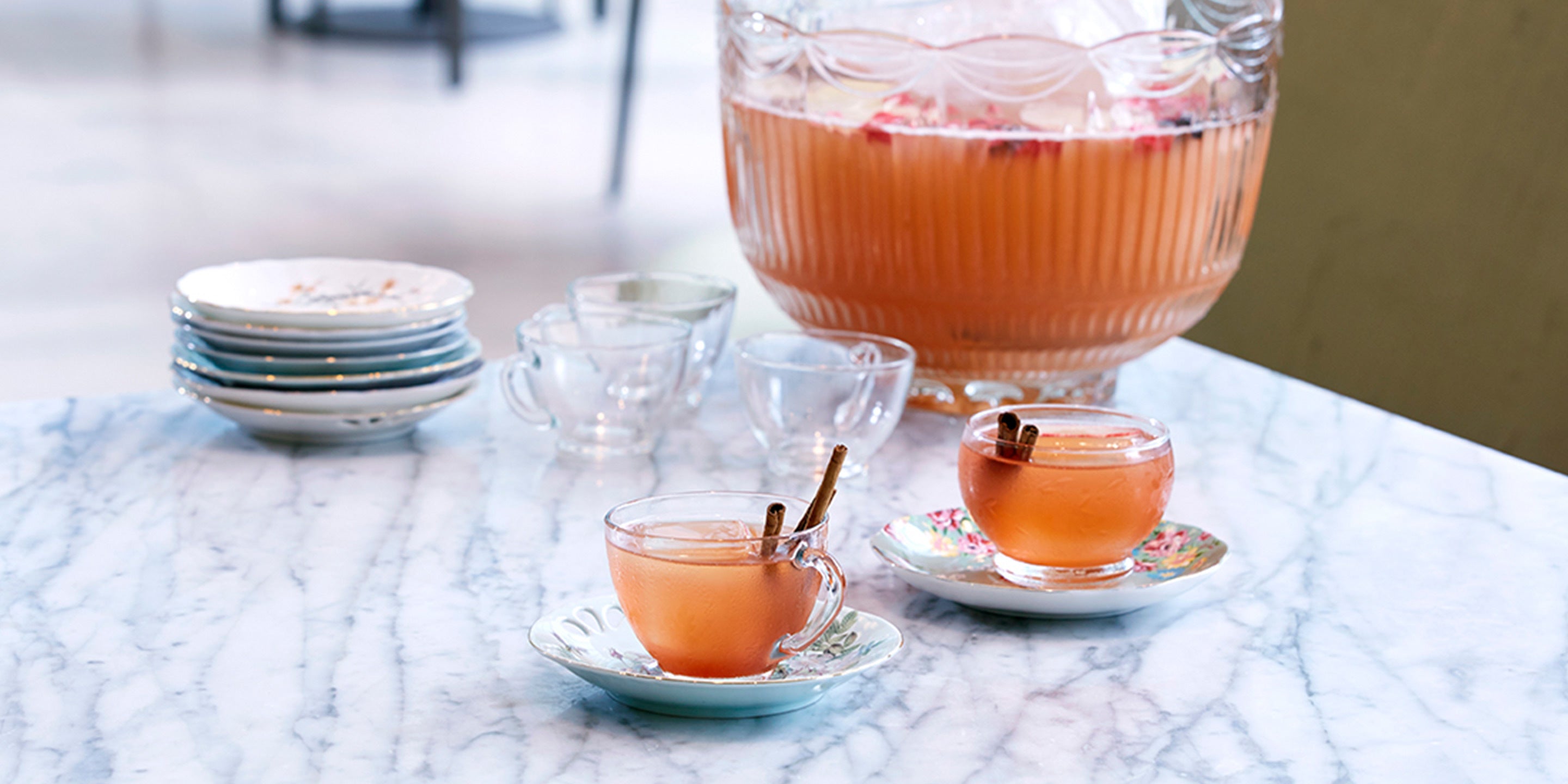 Harvest Apple Punch in glasses with a full punchbowl in background