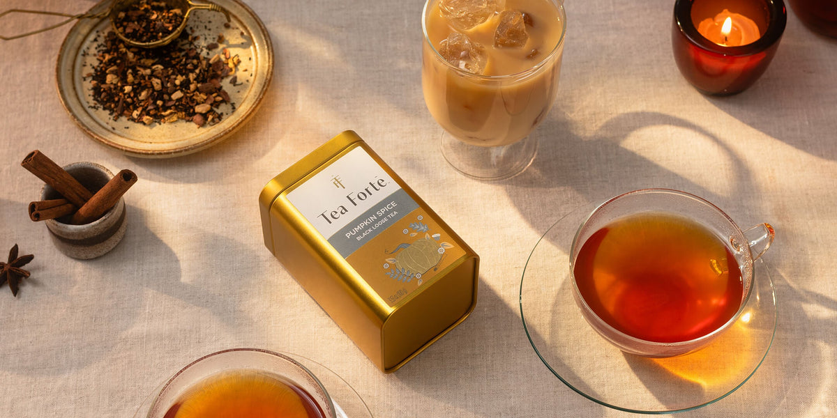 Pumpkin Spice Loose Tea Canister with cups of tea and spices on a table