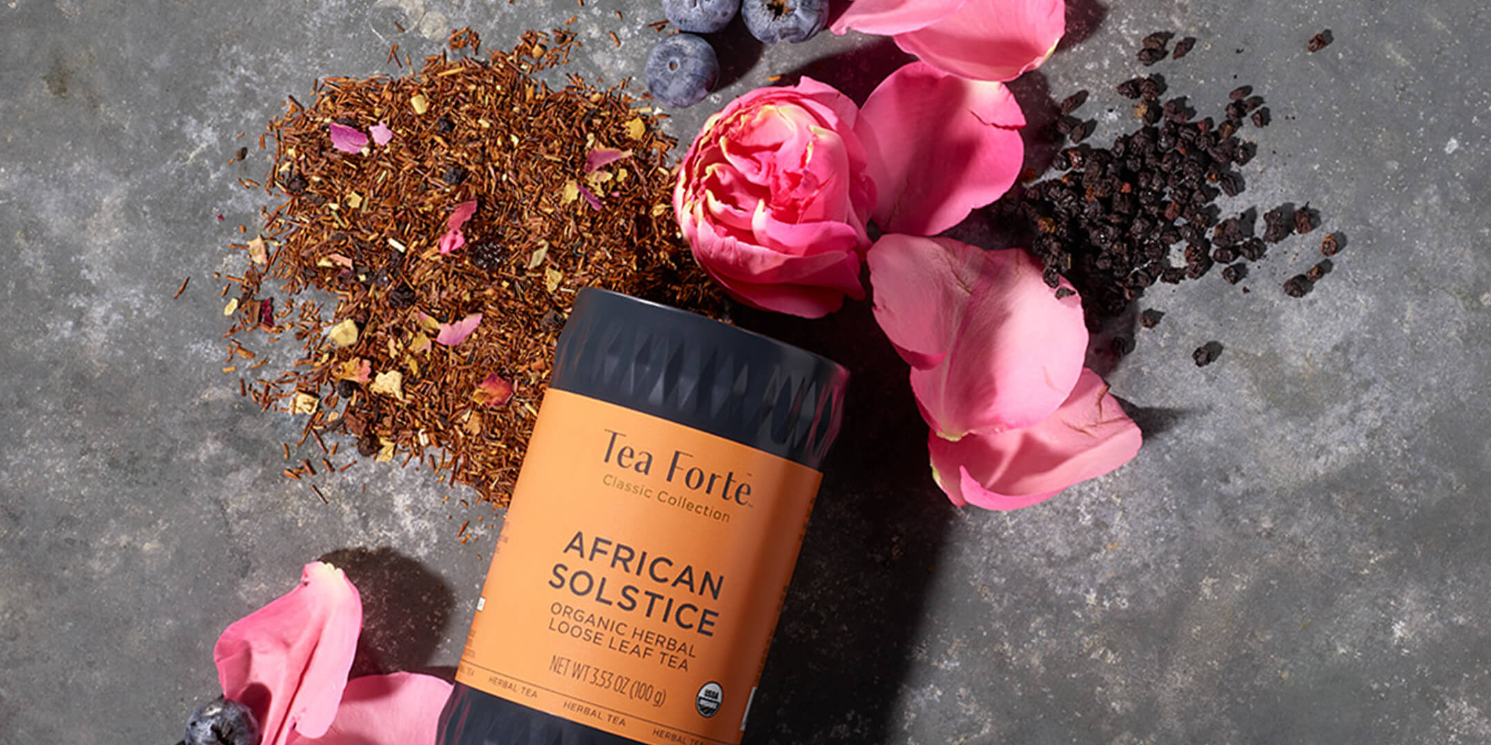 African Solstice Loose tea canister with ingredients and tea pouring out