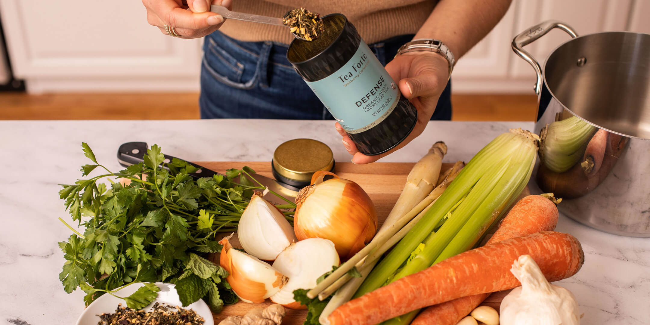 Making sipping broth with Defense loose tea canister and fresh vegetables