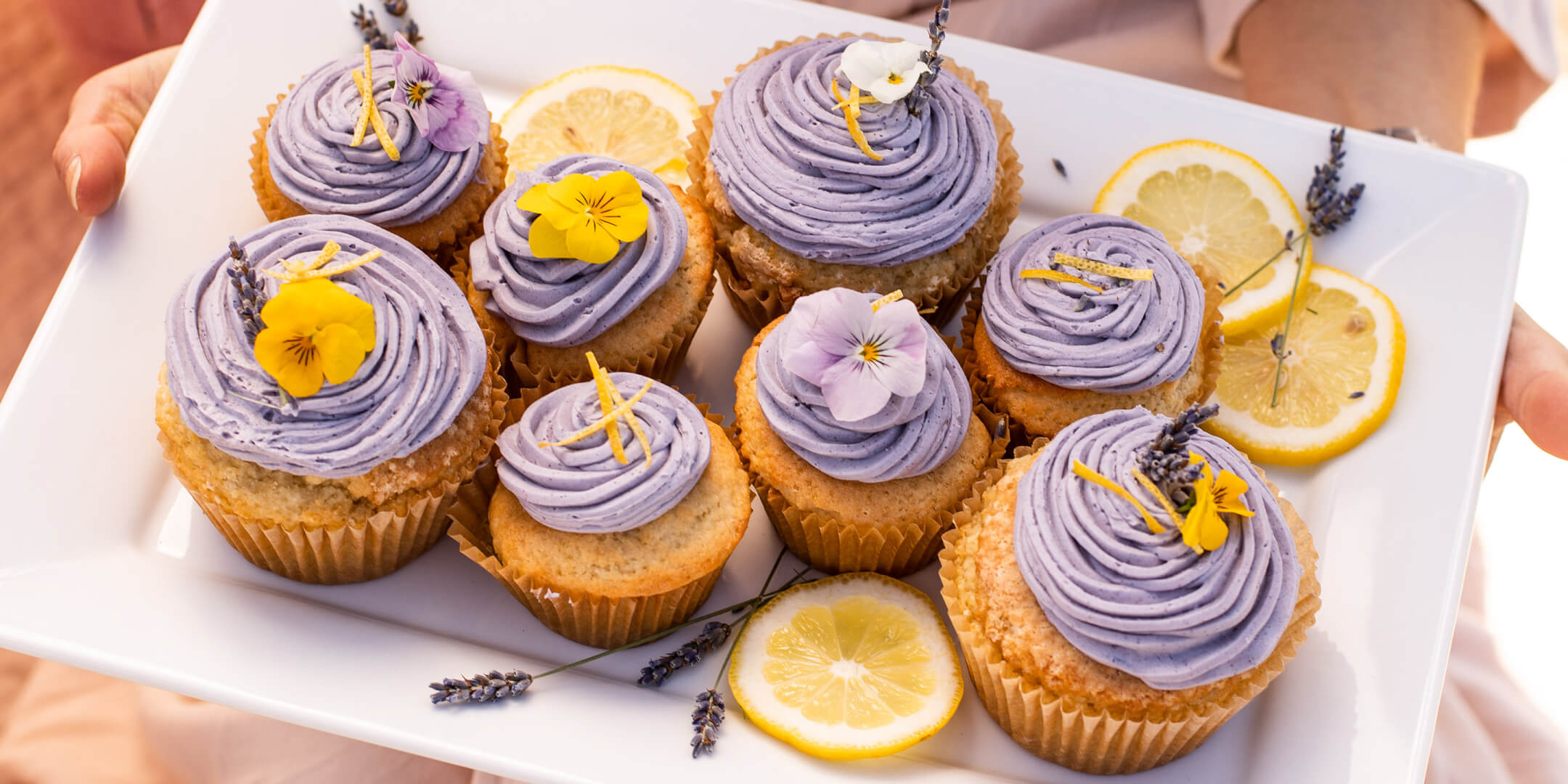 Lemon Lavender cupcakes frosted with yellow and purple buttercream and edible flowers