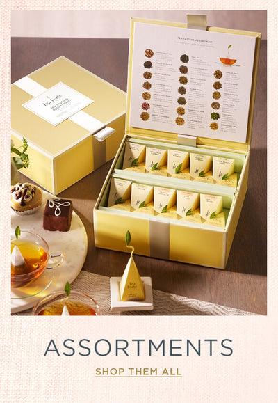 Tea Chest Tea Tasting Assortment with open lid and infuser on a tray