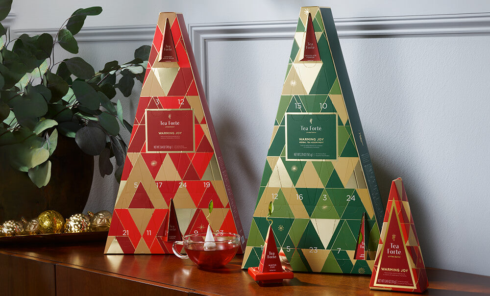 Warming Joy Advent Calendars on a table with tea and ornaments