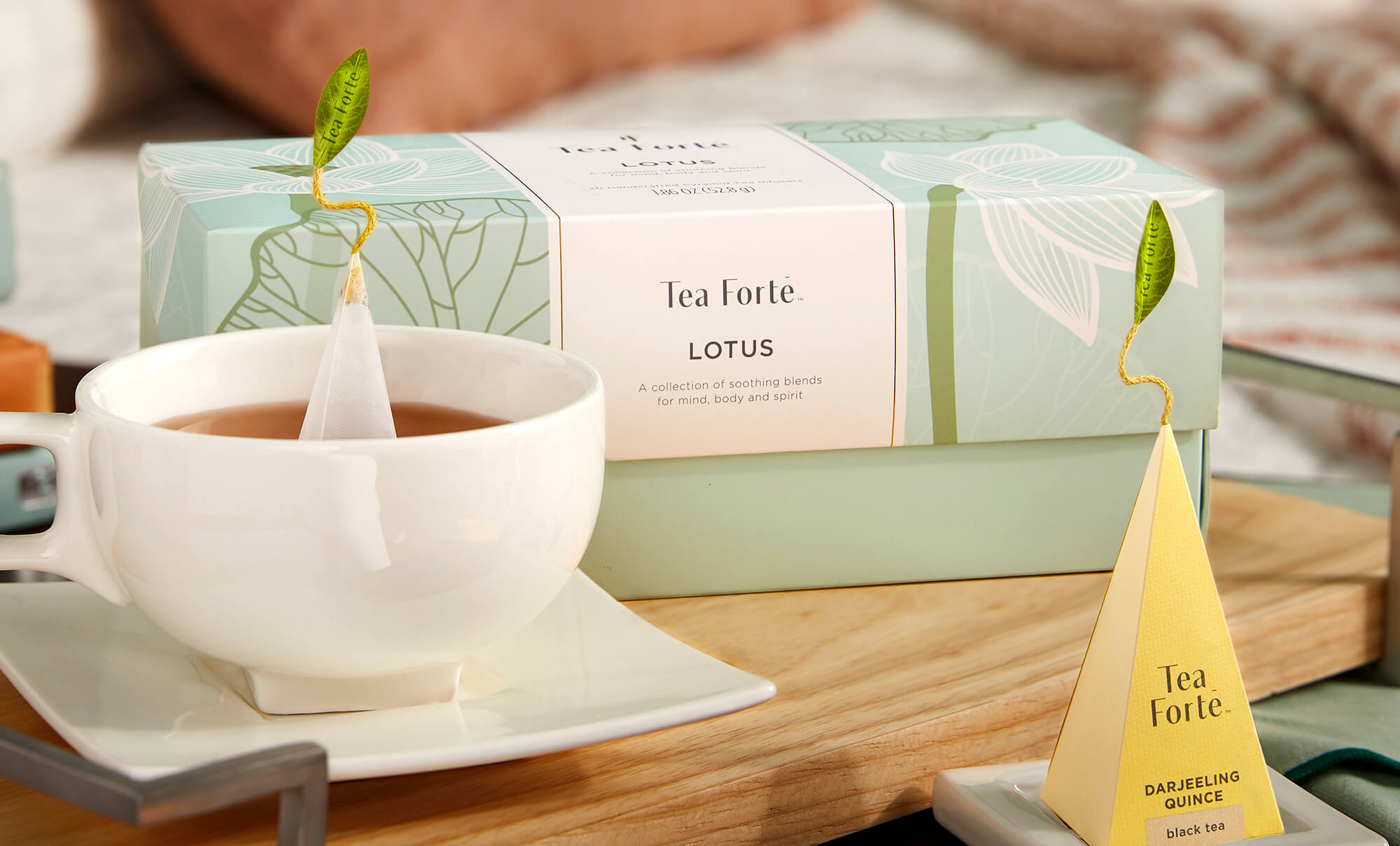 Lotus Collection Presentation Box with teacup and infuser on a table