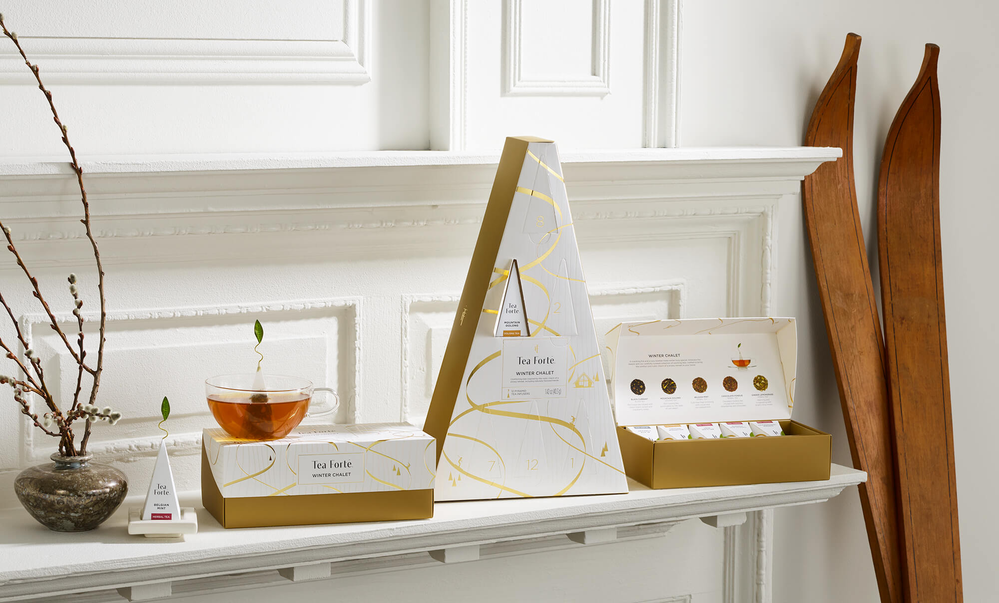 Winter Chalet Collection, Advent and Presentation Boxes on a shelf in a white room with tea