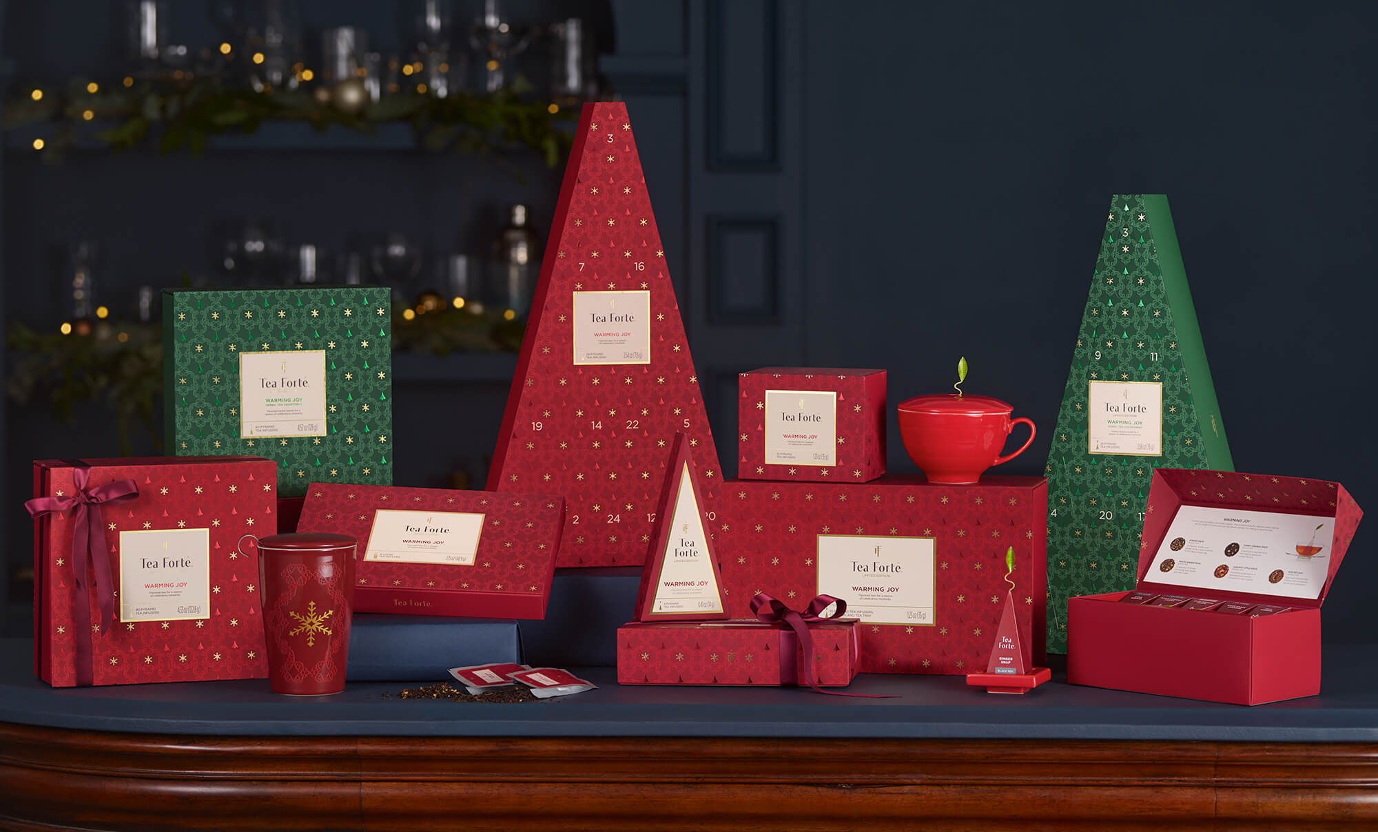 Warming Joy collection of red and green items assembled in front of a dark blue background