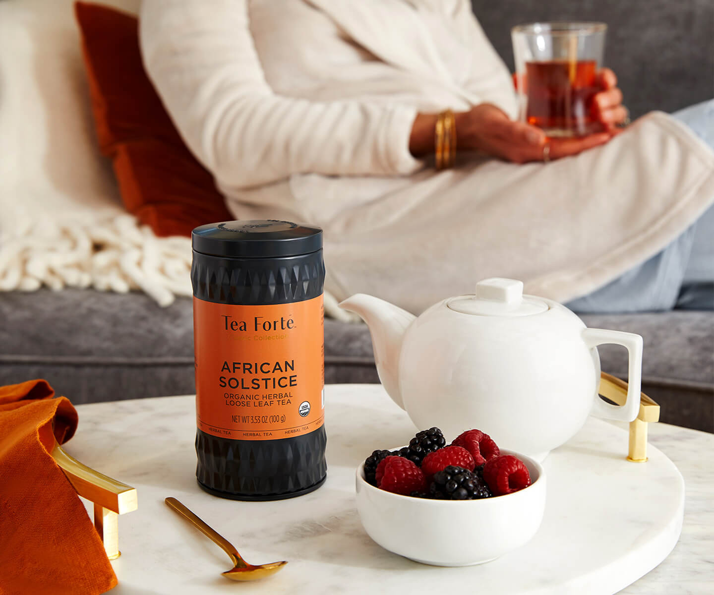 African Solstice Loose tea Canister with a teapot and berries on a table