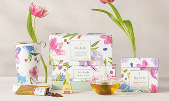 Herbal Retreat Collection with pink tulips and glass teacup on a white background