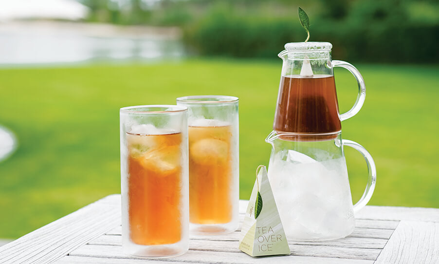 Tea Over Ice Collection with Pitcher Set, infuser and two double-walled iced tea glasses on a white picnic table