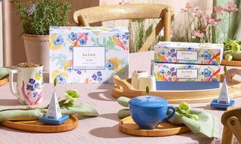 Volaré tea collection items on a table with wildflowers and plants in teh sun