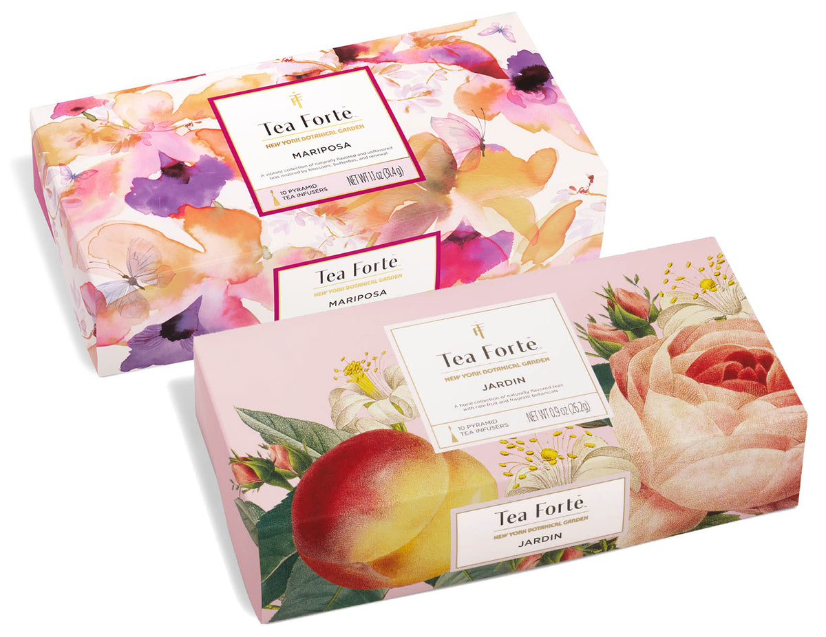 Two Tea Forte boxes with floral designs: Mariposa with purple flowers and Jardin with peach roses and botanical illustrations