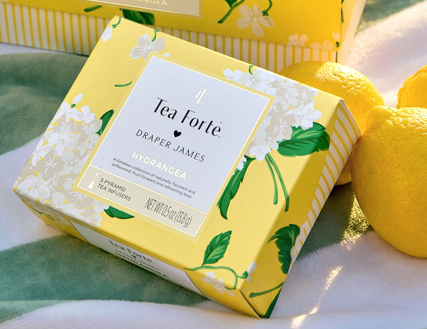 Tea Forte Draper James Hydrangea Mini Peite box on a table with lemons
