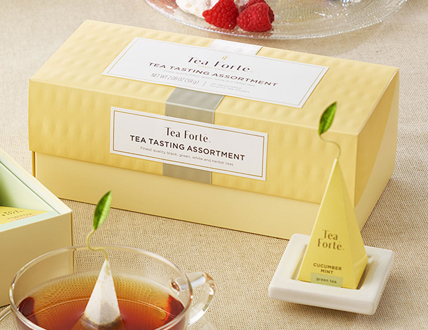 Tea Tasting Assortment in a 20 count presentation box on table with infusers, glass cups