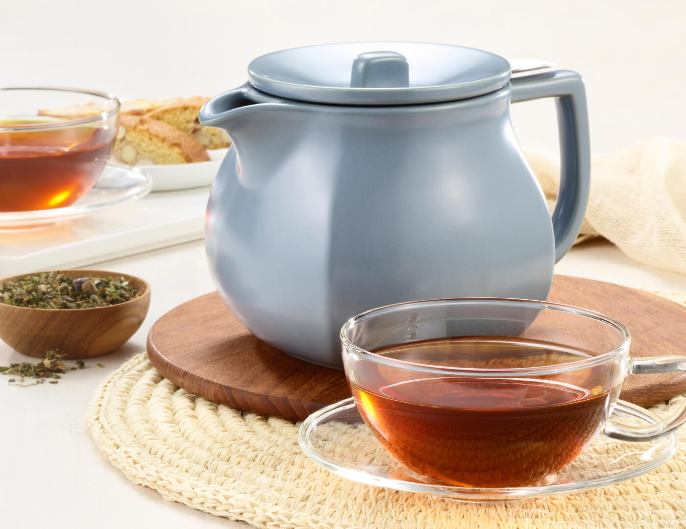 Fiore Stone Blue Teapot with lid and glass cup of tea