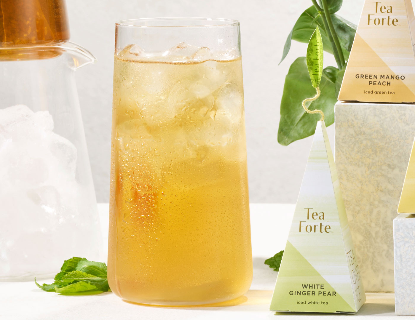 White Ginger Pear Iced tea in a tall glass with pyramid infuser
