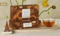 Spiced Chai Petite Presentation Boxes with yellow flowers and a glass of tea and infuser