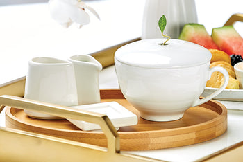 Café Cup Presentation on a bed with flowers and fruit