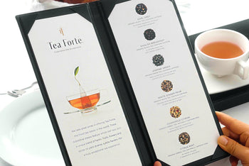 Choosing from a tea menu at a table