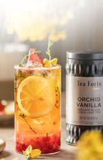 Strawberry Vanilla Iced tea in a glass with Orchid Vanilla Loose canister behind it