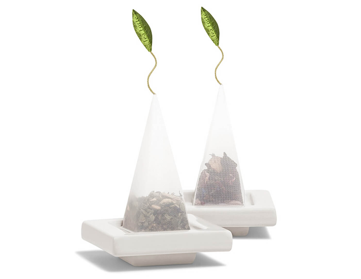 Two Orchid White Tea Trays with pyramid tea infusers resting on top.