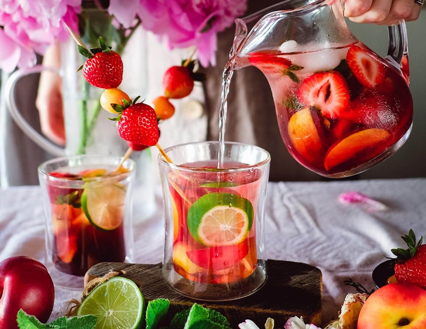 Pouring iced tea with fruit into a Poom glass 