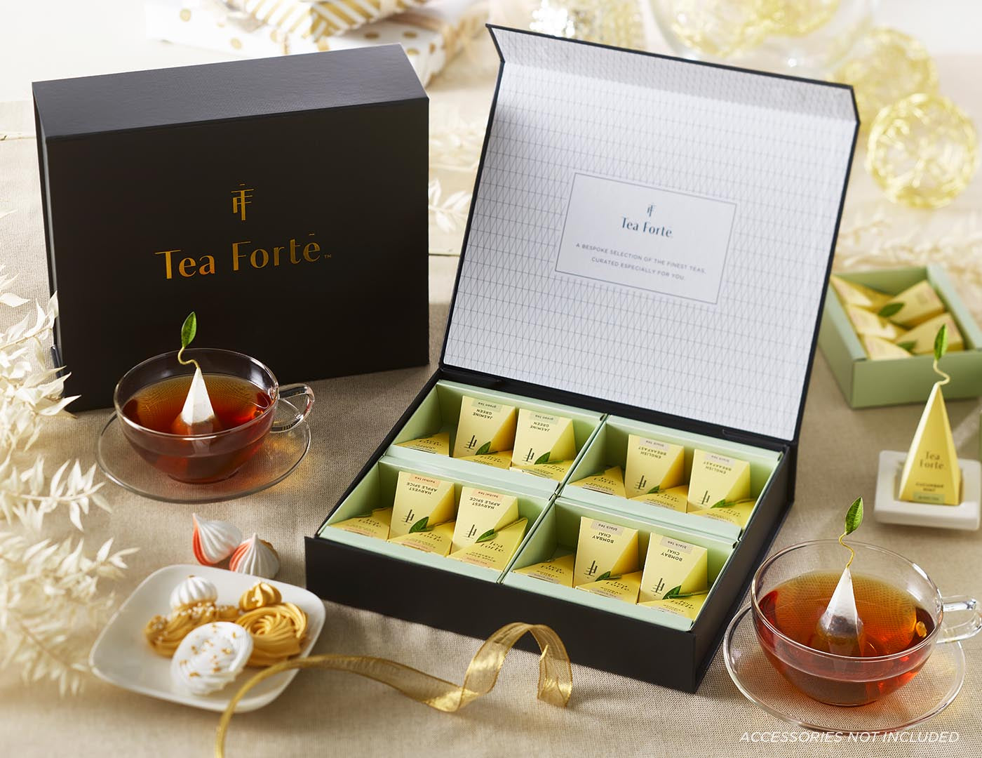 Tea Forté Select Box of 20 pyramid tea infusers, open on a table with ribbon and glass tea cups