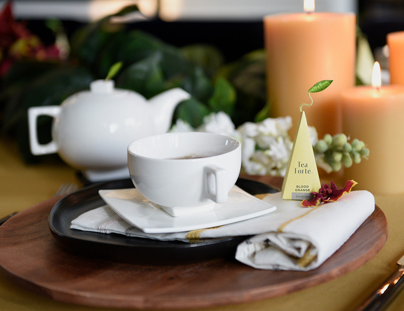 Solstice teacup and infuser with teapot in background